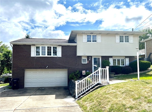 tri-level home with a front yard and a garage