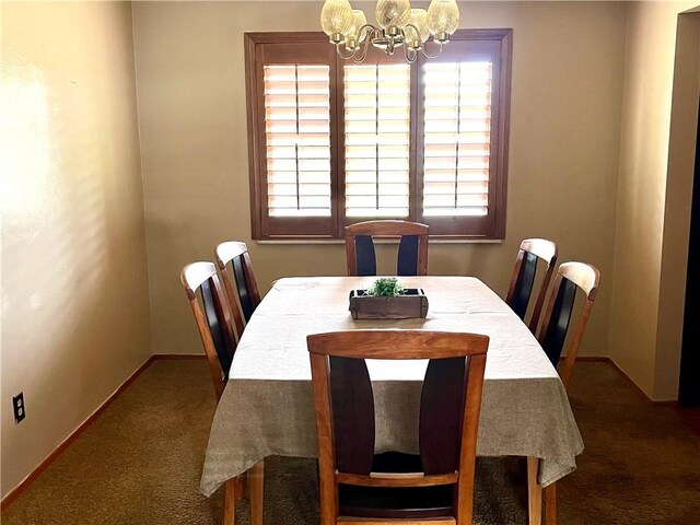 dining space featuring dark carpet, a notable chandelier, and a healthy amount of sunlight