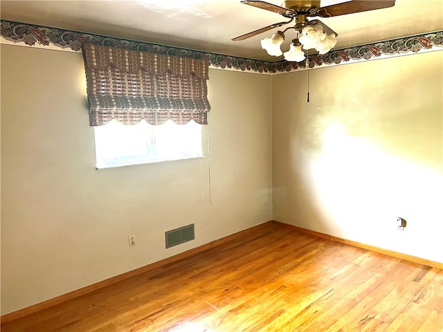 spare room featuring hardwood / wood-style flooring and ceiling fan