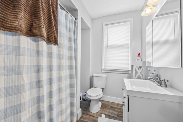 bathroom featuring wood-type flooring, toilet, and vanity