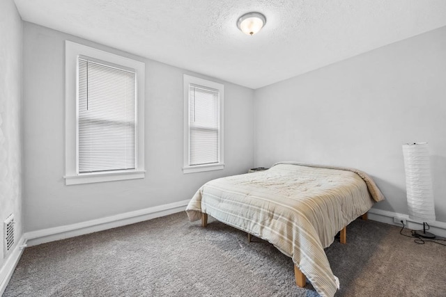 carpeted bedroom with a textured ceiling