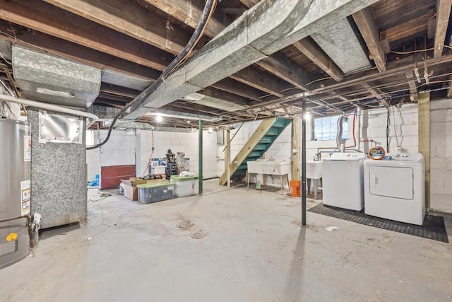 basement featuring separate washer and dryer, gas water heater, and sink