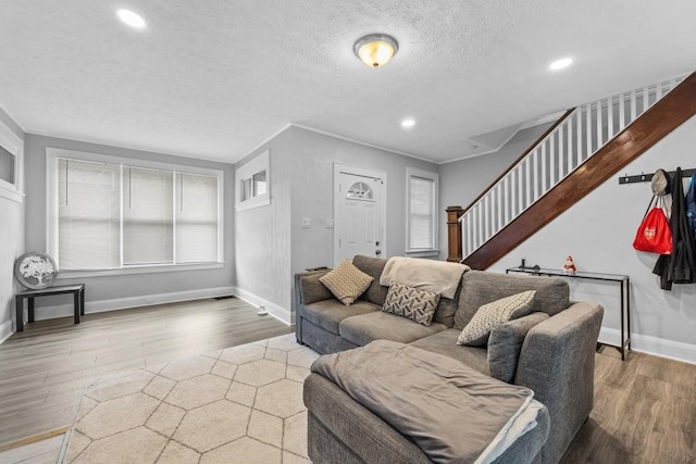 living room with a textured ceiling and wood-type flooring