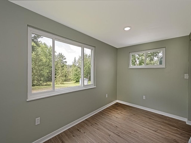 empty room with hardwood / wood-style floors