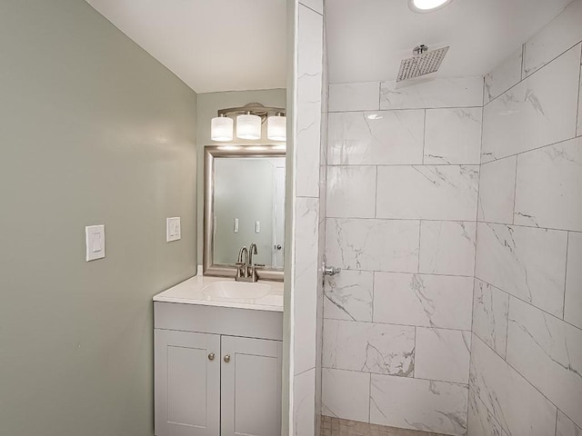 bathroom featuring vanity and tiled shower