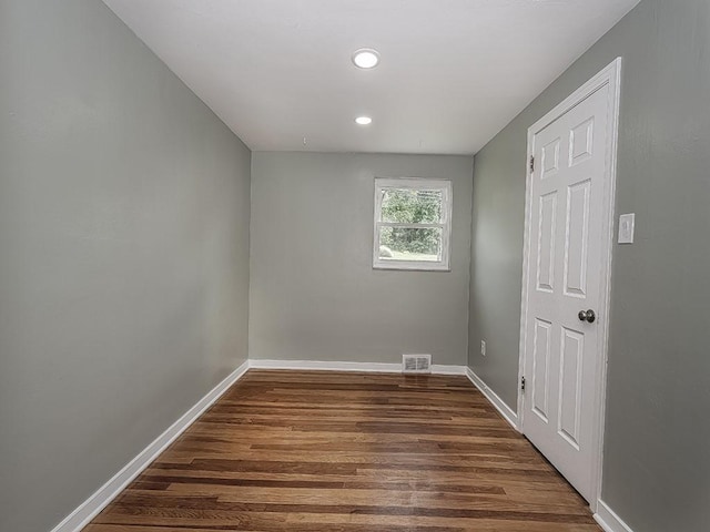 empty room with dark wood-type flooring