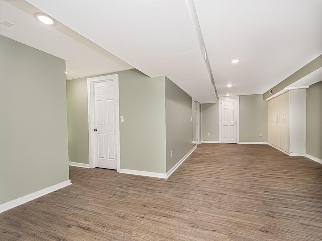 basement with hardwood / wood-style floors