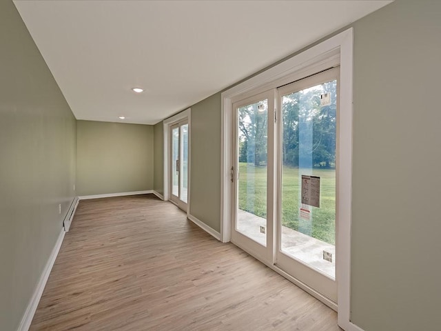 entryway featuring a baseboard radiator and light hardwood / wood-style flooring