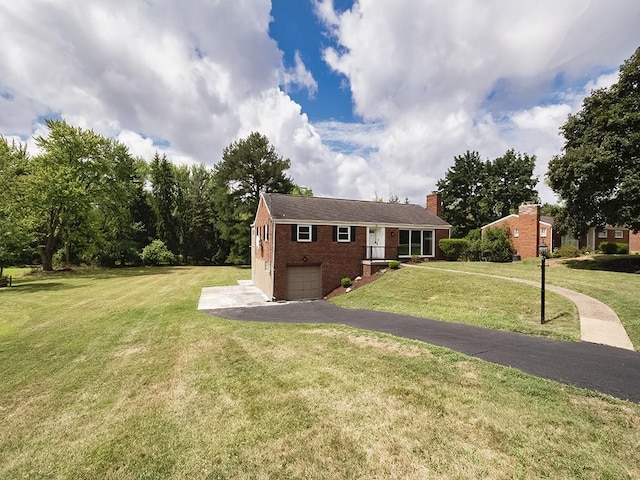 view of front of home featuring a garage and a front lawn