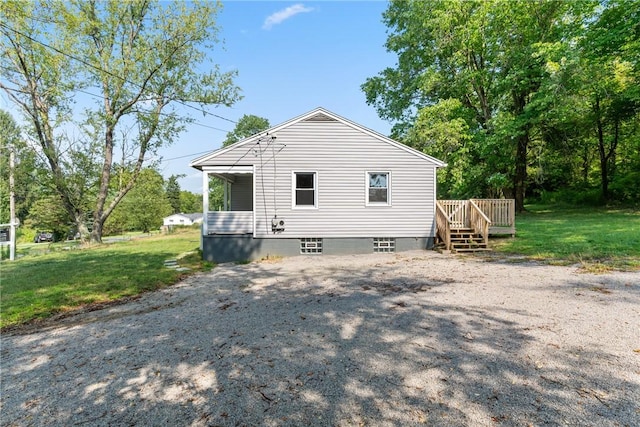 rear view of house featuring a yard