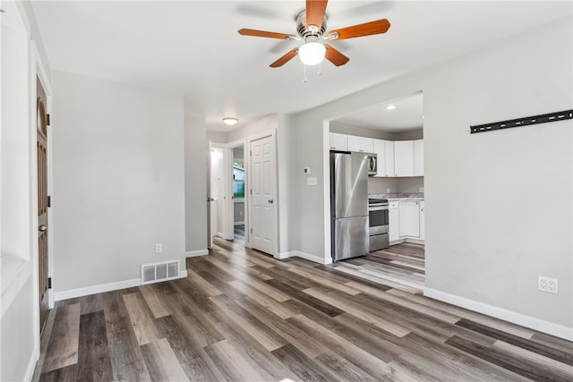 unfurnished living room with ceiling fan and wood-type flooring