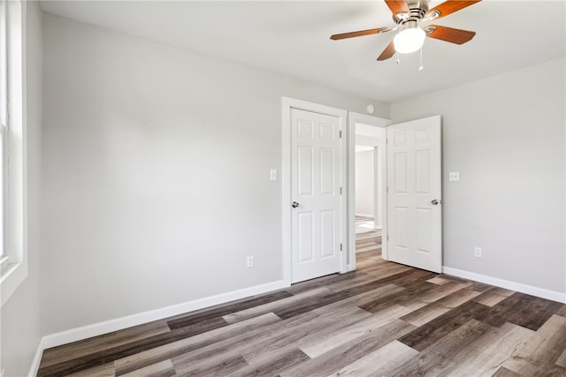 unfurnished room with ceiling fan and wood-type flooring