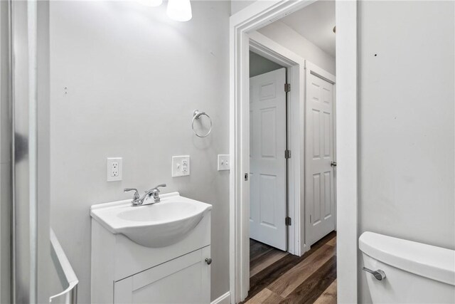 bathroom featuring hardwood / wood-style floors, toilet, and vanity