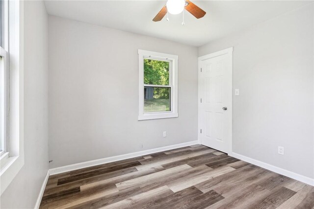 empty room with hardwood / wood-style floors and ceiling fan