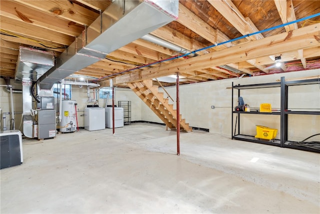 basement featuring washer / clothes dryer, heating unit, and water heater