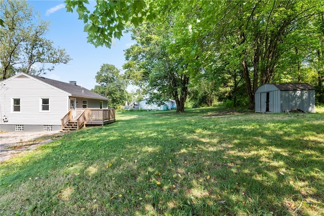 view of yard featuring a shed and a deck