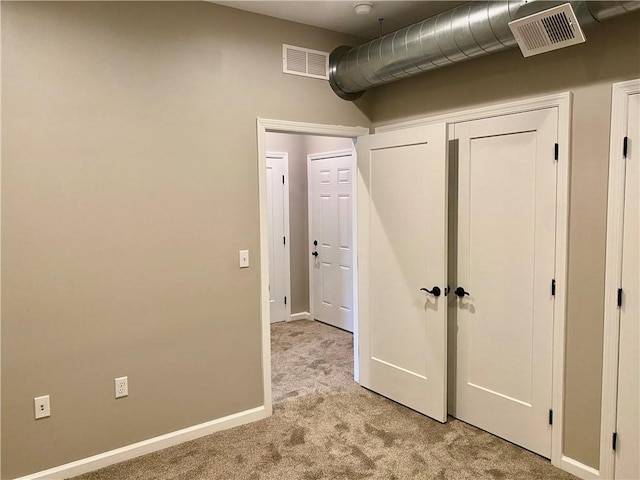 unfurnished bedroom with light colored carpet