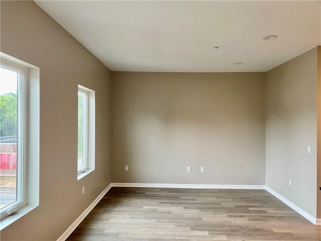 spare room with light hardwood / wood-style flooring