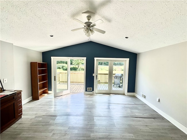 interior space featuring ceiling fan, french doors, light hardwood / wood-style flooring, and vaulted ceiling