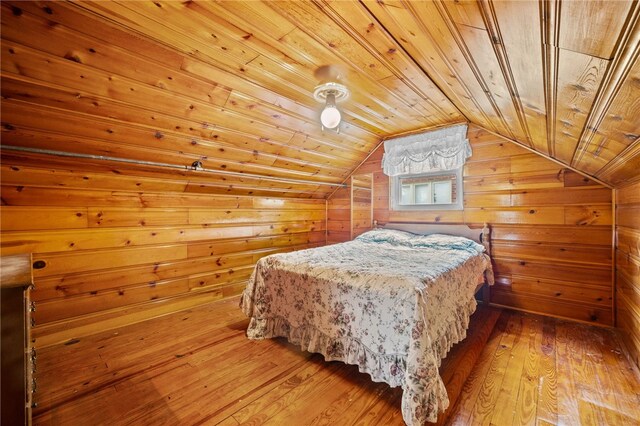 bedroom featuring wooden ceiling, wooden walls, and wood-type flooring