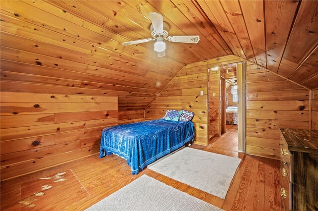 bedroom featuring ceiling fan, wooden ceiling, light hardwood / wood-style flooring, and lofted ceiling