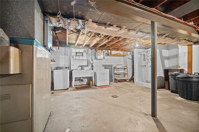 basement featuring washer and clothes dryer and sink