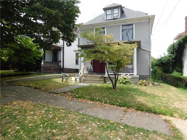 view of front of house with a porch and a front yard