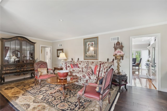 living room with ornamental molding and hardwood / wood-style floors