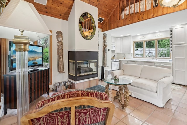 living room featuring a multi sided fireplace, light tile patterned floors, high vaulted ceiling, and wood ceiling