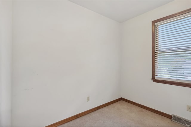 carpeted empty room featuring plenty of natural light