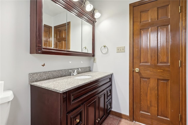 bathroom featuring tile patterned floors, toilet, and vanity