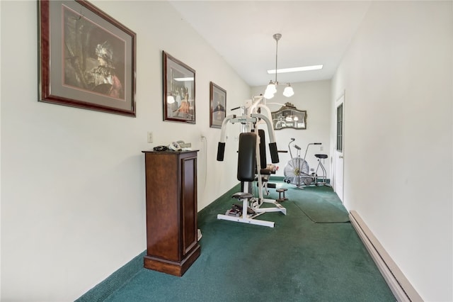 workout room featuring a notable chandelier, carpet, and baseboard heating