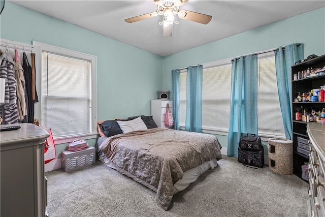 bedroom with light carpet and ceiling fan