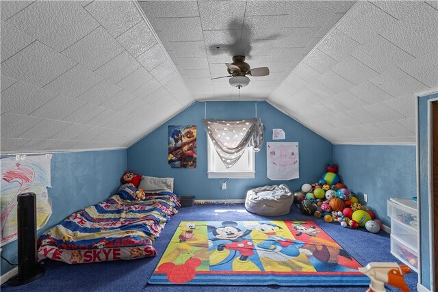 carpeted bedroom featuring ceiling fan and vaulted ceiling