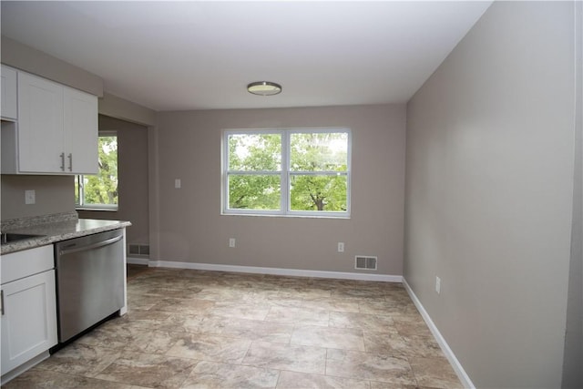 kitchen featuring visible vents, a healthy amount of sunlight, white cabinets, and stainless steel dishwasher