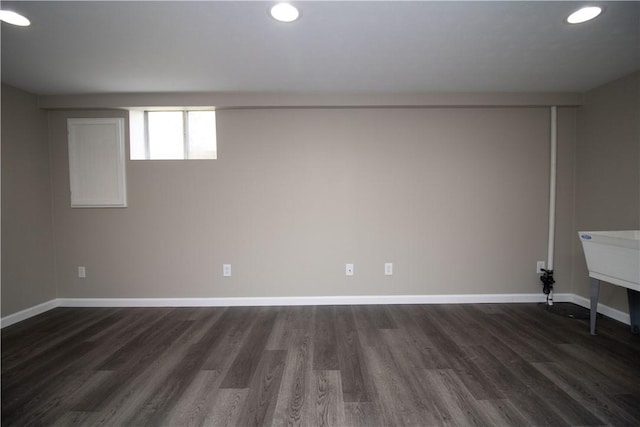 basement featuring dark wood-style floors, recessed lighting, and baseboards