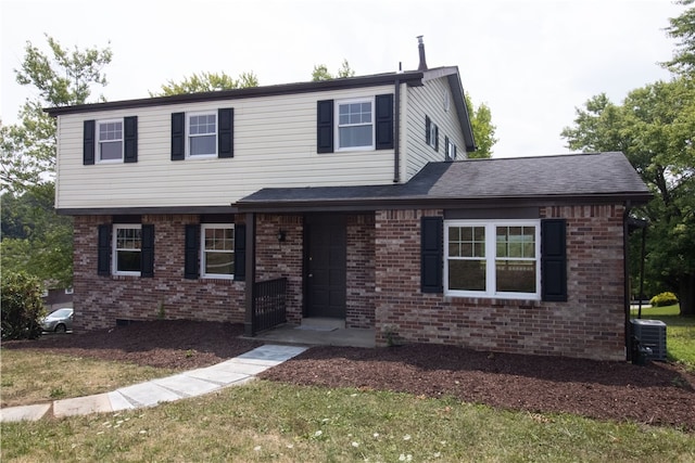 view of front of house with brick siding, central air condition unit, and a shingled roof