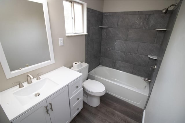 full bath featuring vanity, washtub / shower combination, toilet, and wood finished floors