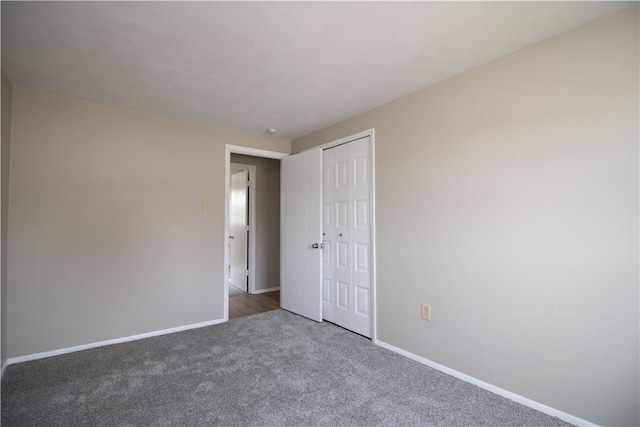 unfurnished room featuring baseboards and carpet floors