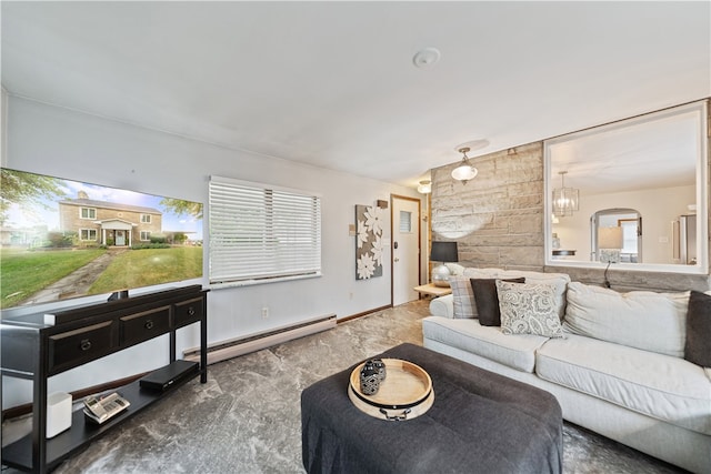 carpeted living room featuring an inviting chandelier, a healthy amount of sunlight, and a baseboard heating unit