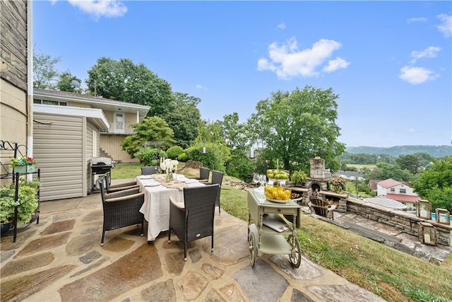 view of patio / terrace with an outdoor stone fireplace