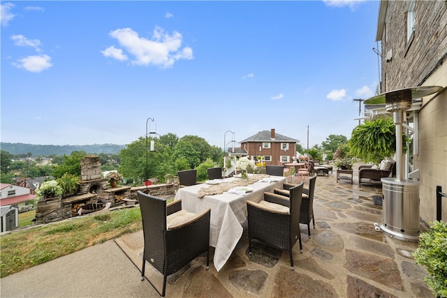 view of patio with an outdoor living space with a fireplace