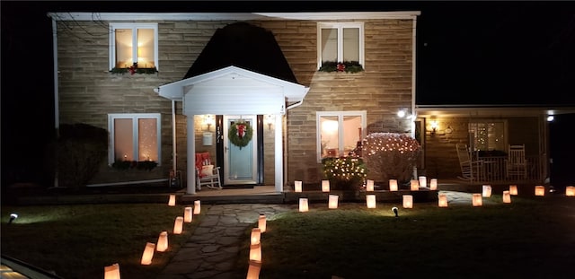 view of exterior entry at twilight