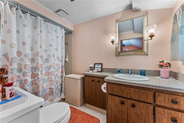 bathroom with vanity, tile patterned flooring, and toilet