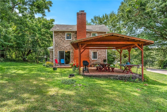 rear view of house with a patio, a gazebo, and a lawn