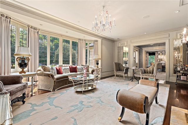 living room with light hardwood / wood-style floors, a notable chandelier, and crown molding