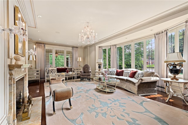 living room with an inviting chandelier, crown molding, and wood-type flooring