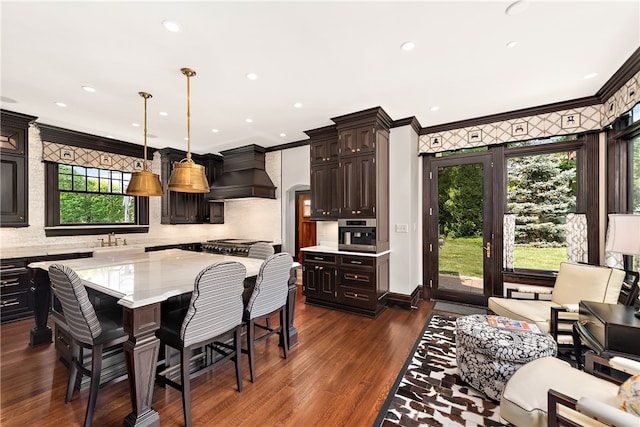 dining room with dark hardwood / wood-style flooring, a healthy amount of sunlight, and crown molding