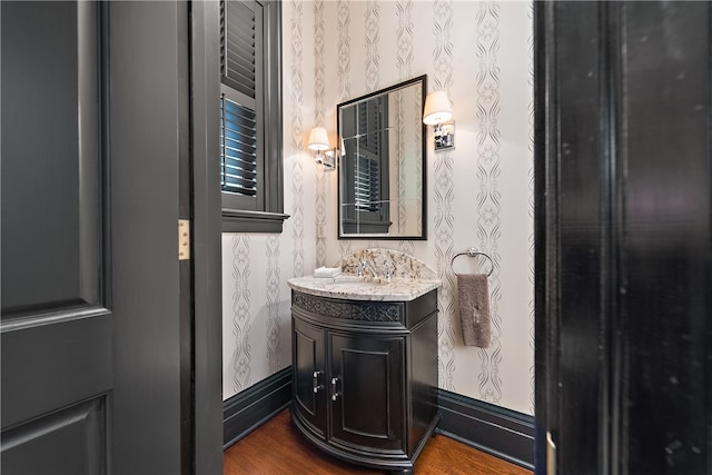 bathroom with vanity and hardwood / wood-style floors