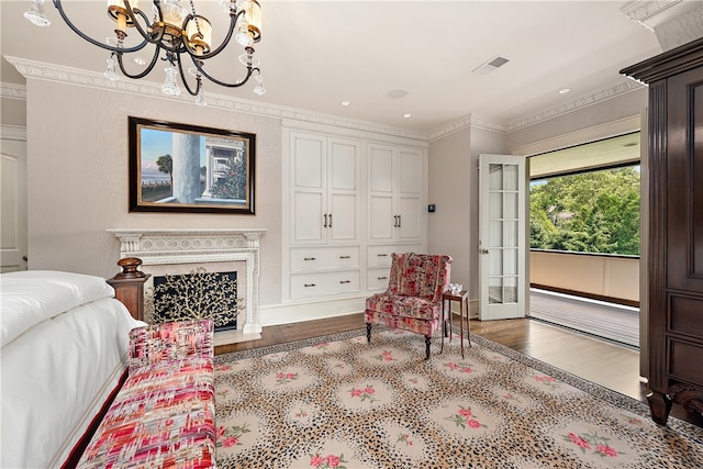 bedroom featuring ornamental molding, a notable chandelier, and hardwood / wood-style floors